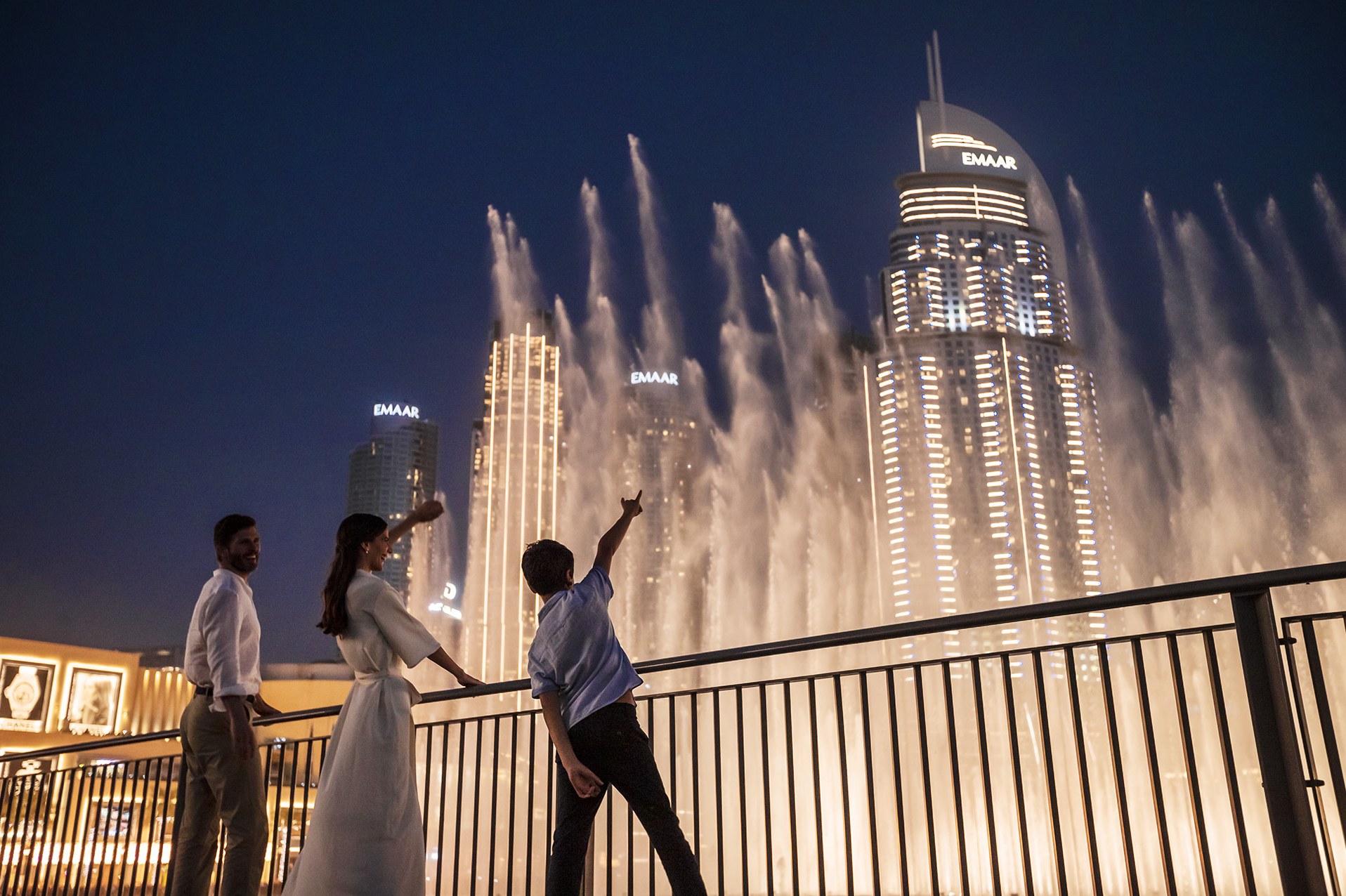 The Dubai Fountain at dusk, framed by the Address skyline